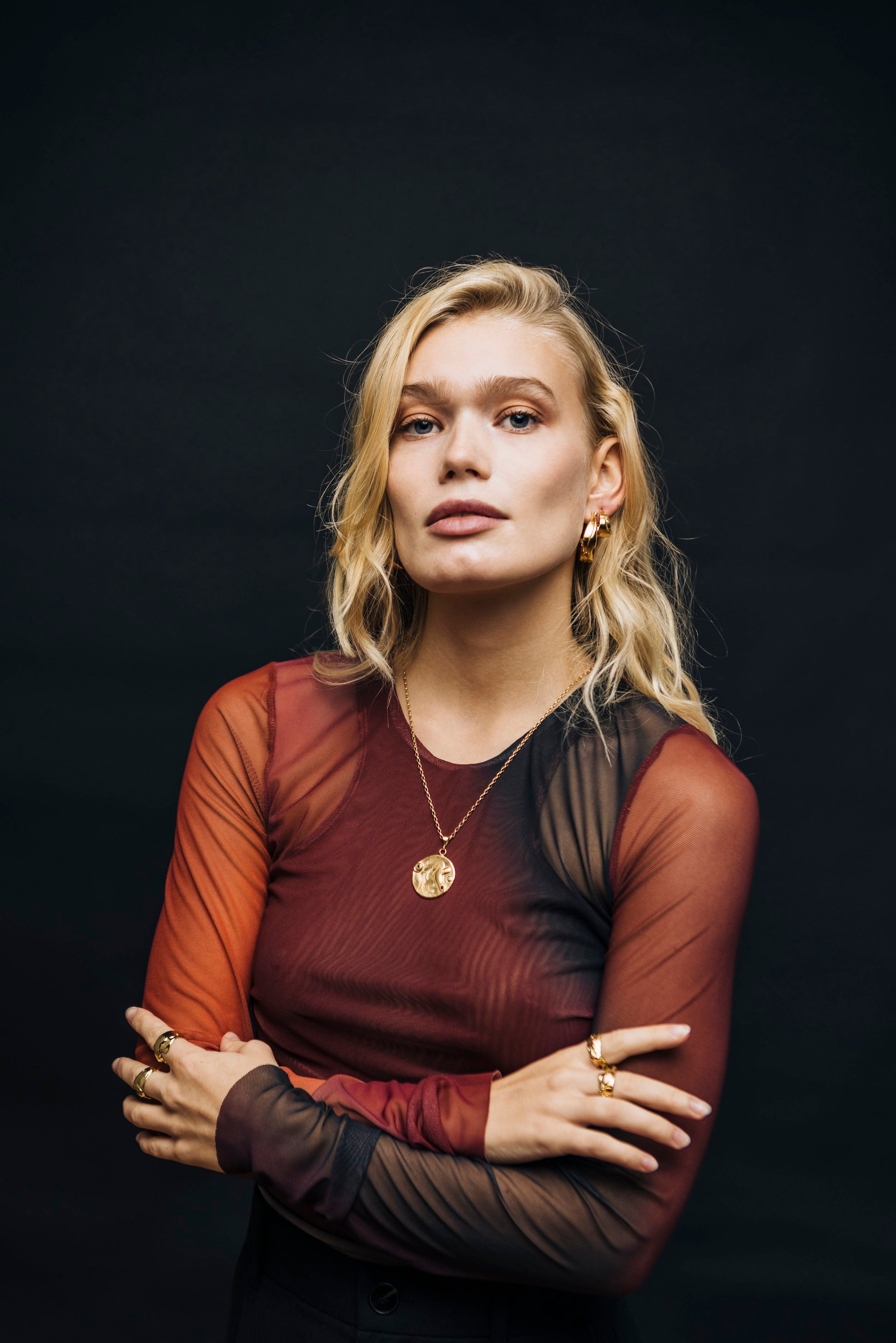 Model photo of Bocavolcan's beautiful Gold Plated 925 Silver Lahar necklace with Sapphire Ruby and Blue Sky Topaz stones Lahar necklace worn by a blonde model handcrafted in Valencia