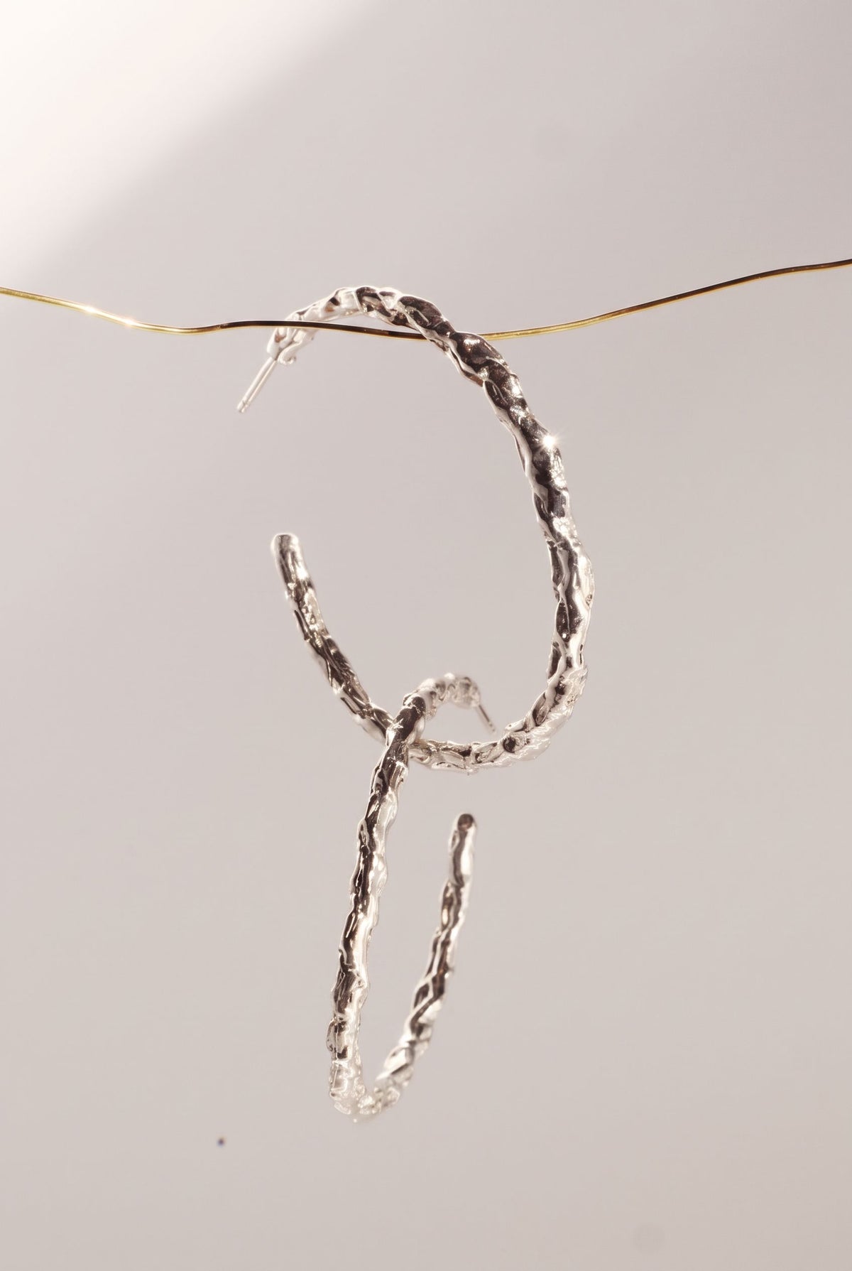 Saturno Origen Hoops, silver version, hoop earrings by Bocavolcan